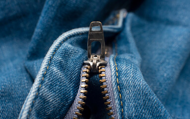 Closeup of zipper in blue jeans. Zipper with lock. A piece of denim