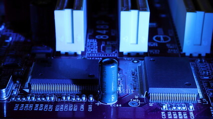 Concept of micro chips in blue backlight. Soft focus. Detail of microchips on an electronic circuit board. Standard marking of electronic components. Lack of chips for cars.