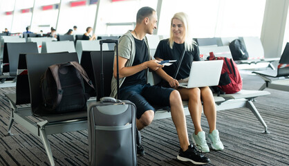 lovely couple with laptop at airport