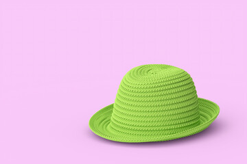 Vintage green straw beach sun hat isolated on pink background and sun protection