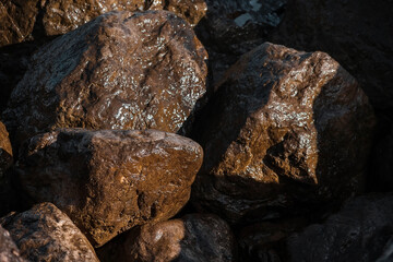Strengthening the shore from erosion with concrete tetrapods. The seashore with concrete blocks. The element of water. Waves break on concrete.