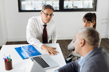 Business people talking to each other while having a business meeting in the office
