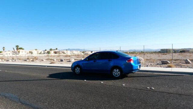 Car Drives Past On Desert Road