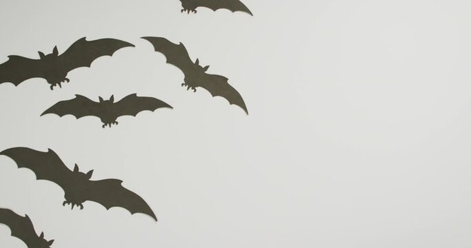 Multiple halloween bat icons with copy space on grey background
