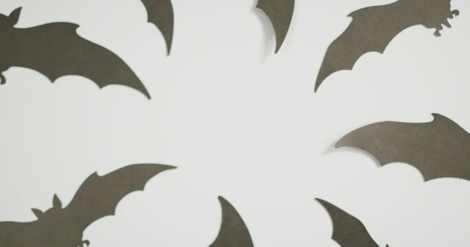 Digital animation of multiple halloween bat icons against grey background