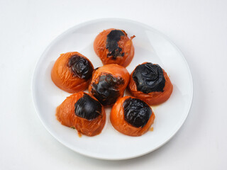 roasted tomatoes served on a white plate