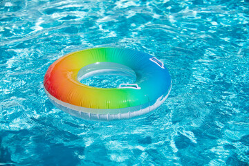 Pool float, ring floating in a refreshing blue swimming pool. Summer background.