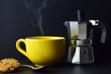 Yellow, hot mug, rising smoke, coffee pot in outline, black background and copy space.