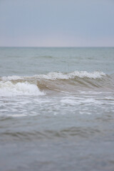 Seascape view of waves in Baltic sea. Photo taken on a warm overcast day.