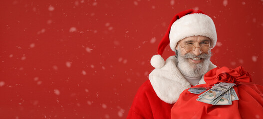 Santa Claus with bag, gift cards and banknotes on color background with space for text