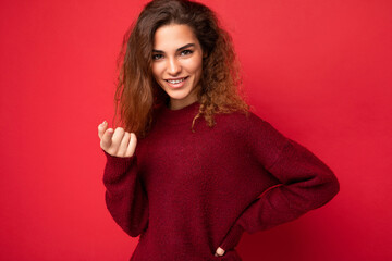 Young beautiful self-confident curly brunette woman with sincere emotions poising isolated on...