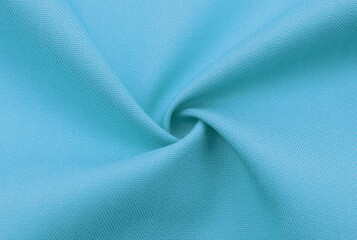 Blue fabric background with folds and waves. Textile. Material. Texture