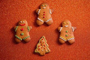 gingerbread man on bright orange christmas background with space