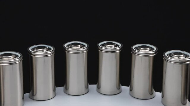 The concept of the new high-capacity 4680 format lithium batteries on a production line
