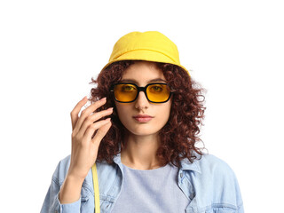 Woman in stylish sunglasses wearing bucket hat on white background