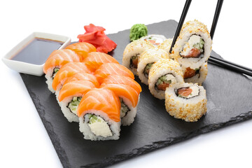 Delicious sushi rolls on white background