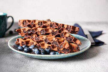 Plate of delicious Chocolate Belgian Waffles with blueberry on table