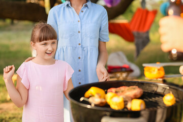 Happy family at barbecue party on summer day