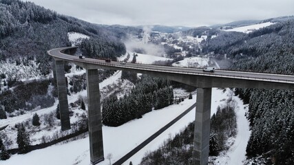 Bridge with traffic in snowy valley