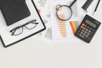 Business graphs, charts, magnifying glass and calculator on table. Financial development, Banking Account, Statistics