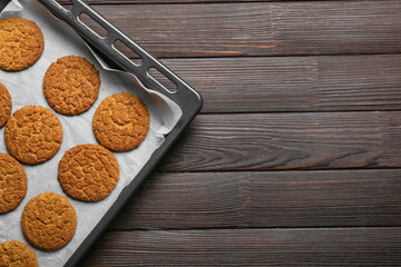 Baking dish with tasty hojicha cookies on black wooden background, closeup