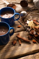 Lush composition - two blue coffee cups on a wooden table, decor, sweets. No people. Restaurant, hotel, coffee shop, menu design, culinary blog. Pastel tones.