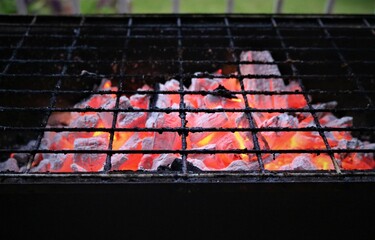 burning charcoal under the grid