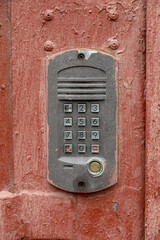 old intercom at the entrance to a residential building