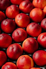 Top view of juicy nectarines in a box