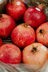 Fototapeta na wymiar Fresh ripe pomegranates at the market
