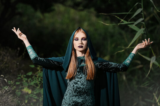 Portrait of young witch outdoors