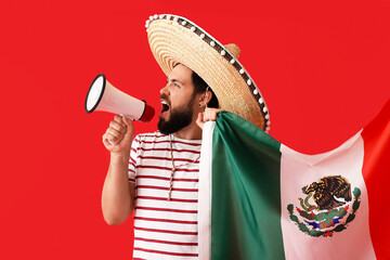 Handsome man in sombrero, with Mexican flag and megaphone on color background