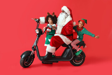 Cute little elves with Santa Claus and gifts riding bike on red background