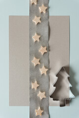 christmas tree cookie cutter with wooden stars on silver crepe paper ribbon