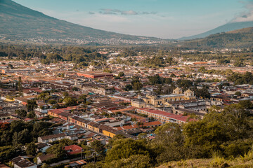 Aerial sunset view of the center of Antigua Guatemala with Iglesia de la Merced and surrounding mountains