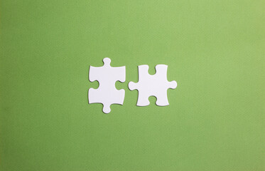 two pieces of the puzzle about to connect. concept of union and compatibility in the team....