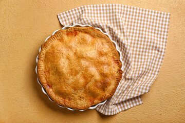 Baking dish with tasty chicken pot pie on beige background