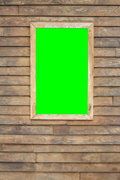 vertical image of a wooden background with a framed window in which there is a chroma key for attaching images or video. copy space