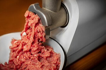he process of twisting meat in a meat grinder. Minced pork and beef. Meat mince.