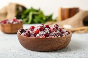 Bowl with tasty sugared cranberries on white background