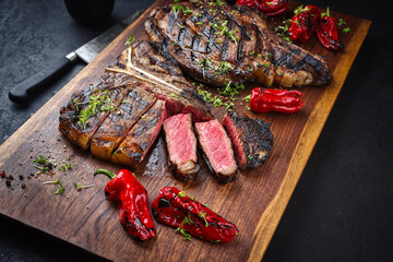 Rustic traditional barbecue dry aged wagyu t-bone and cote de boeuf beef steak with paprika and...