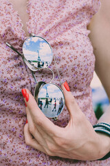 woman holding glasses with eiffel tower reflection