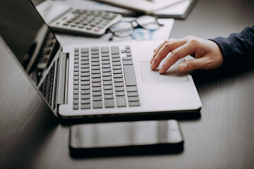 Close up view of hand's women using laptop computer working business report analytic at home,...