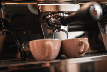 Fototapeta na wymiar Espresso machine pours fresh black coffee closeup