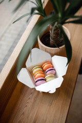 Macaroon cookies in a box on a wooden table