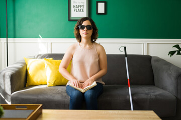 Beautiful woman with a disability learning to read