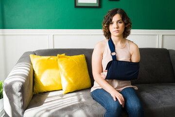 Portrait of an injured woman with an arm sling