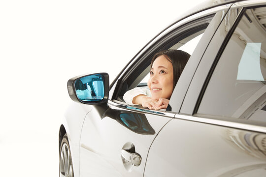 車の窓から外を眺める女性