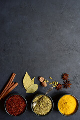 Fototapeta na wymiar Set of spices : turmeric, saffron , dried thyme, cinnamon, nutmeg, anise. Top view with copy space.