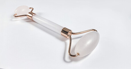 White massage quartz roller for the face close-up isolated on a white background. Beauty and care...